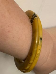 These gorgeous bangles came from a Maryland estate and are a rare find indeed! These appear to be marbled Bakelite bracelets made by Les Bernard, most likely in the early 70's. Each bangle features beautiful butterscotch yellow marbling, accented with a dark greenish hue. One of the bangles has the original sticker still on it. These bracelets are approximately 3.35 inches across, with an inner diameter of approximately 2.4 inches. The width of each bangle when laying flat is approximately 0.4 i Vintage Yellow Round Bracelets, Retro Yellow Bangle Bracelets, Retro Yellow Bangle Bracelet, Yellow Vintage Bracelet As Gift, Yellow Bangle Bracelets For Formal Occasion, Bakelite Necklace, Twist Beads, Deco Beads, Bakelite Bracelets