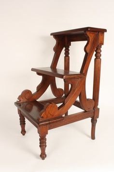 an old wooden chair that is turned into a shelf with two shelves on each side