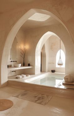 a bathroom with a large jacuzzi tub next to two sinks