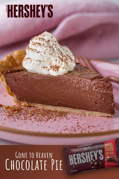 a piece of chocolate pie with whipped cream on top and hershey's bar in the background