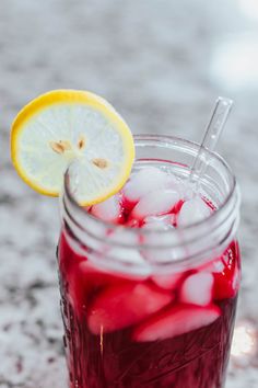 a mason jar filled with ice and lemon slices