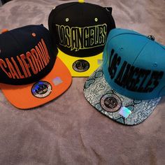 3 Tsc Snapback Caps. 2 Los Angeles And 1 California Cap! The Bills Are All Different Material. The Yellow Is A Type Of Neoprene, Orange Is Traditional And Blue Is A Raised Snake Print! All Are New With Tags, Labels And Stickers! Trendy Snapback Hat For Sports Events, Trendy Adjustable Snapback Hat For Sports Events, Casual Multicolor Baseball Cap With Letter Print, Multicolor Adjustable Casual Hat, Casual Multicolor Adjustable Fitted Hat, Multicolor Casual Fitted Hat, Casual Multicolor Flat Bill Fitted Hat, Casual Multicolor Snapback Hat For Sports, Trendy Multicolor Snapback Hat For Streetwear