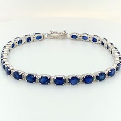 14k Sapphire Diamond Tennis Bracelet  Prong Set BLUE SAPPHIRES- SHAPE: Oval SIZE: 5x4mm # OF STONES: 26 WEIGHT: 13.77 carats DIAMOND- # OF STONES: 52 WEIGHT: 0.52 carats Gold Weight: 9.38 grams Sapphire Tennis Bracelet Fine Jewelry With Prong Setting, Sapphire Diamond Tennis Bracelet Gift, Classic Sapphire Tennis Bracelet With Prong Setting, Classic Sapphire Tennis Bracelet For Anniversary, White Gold Sapphire Gemstone Tennis Bracelet, Classic Sapphire Diamond Tennis Bracelet, Sapphire Tennis Bracelet With Round Diamonds, Sapphire Tennis Bracelet With Diamond Accents For Anniversary, Sapphire Tennis Bracelet With Diamond Accents As Gift