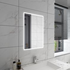 a bathroom with a sink, mirror and window on the wall next to each other