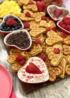 some heart shaped waffles and berries on a table