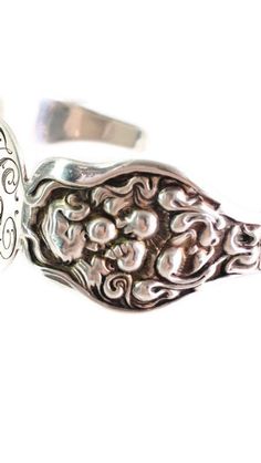 "Exceptional and beautiful piece of Art Nouveau jewelry from the early 1900's. This Unger Brothers cuff bracelet is rendered in sterling silver featuring a beautiful Art Nouveau maiden and floral design on either side of an engraved oval. This piece has been monogrammed with three stylized initials. The underside of the oval has the Unger Brothers hallmarking. This rare piece is in excellent condition with some light marks and nicks to the engraved oval. Measures approximately 5 3/4\" around, no Antique Sterling Silver Cuff Bracelet For Wedding, Heirloom Silver Cuff Bracelet For Weddings, Vintage Sterling Silver Cuff Bracelet For Ceremonial Occasions, Heirloom Style Silver Cuff Bracelet For Anniversary, Heirloom Silver Cuff Bracelet For Anniversary, Ornate Silver Cuff Bracelet For Anniversary, Heirloom Engraved Silver Cuff Bracelet, Ornate Sterling Silver Cuff Bracelet For Anniversary, Art Nouveau Silver Jewelry For Ceremonial Occasions