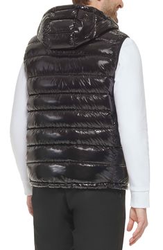 Easy to layer, this puffer-style vest features an attached hood that furthers the comfort. Attached hood Sleeveless 100% polyester Machine wash Imported Model stats: 6'1" height, 32" waist. Model is wearing size M. Down Vest With Padded Collar, Sleeveless Down Vest With Padded Collar, Sleeveless Black Down Outerwear, Black Quilted Nylon Vest, Casual Hooded Nylon Vest, Quilted Black Nylon Vest, Sleeveless Down Puffer Vest, Black Sleeveless Vest With Padded Collar, Hooded Nylon Vest For Streetwear