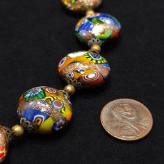 "*Description: This is a gorgeous 1930s millefiori Venetian Murano glass necklace and clip earrings with aventurine gold stone throughout. The necklace is very unique with the fifteen round flattened glass beads and its box clasp that matches the beads. The name millefiori in Italian means \"thousand flowers\". The addition of aventurine gold stone gives the necklace its gold glitter appearance. The earrings match the beads on the necklace with a slightly smaller size. The beads on the necklace Unique Glass Jewelry For Formal Occasions, Multicolor Vintage Jewelry With Unique Variations, Unique Jewelry With Round Glass Beads, Vintage Multicolor Jewelry With Unique Variations, Vintage Czech Glass Jewelry With Polished Beads, Antique Round Beads Jewelry For Party, Unique Glass Jewelry With Round Beads, Vintage Jewelry With Polished Czech Glass Beads, Antique Glass Beaded Jewelry