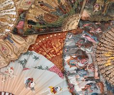 an assortment of decorative hand fan's on display