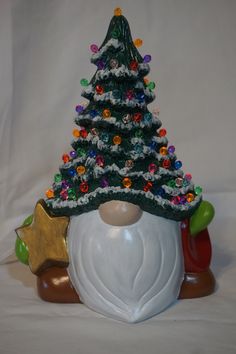 a ceramic christmas tree sitting on top of a white table