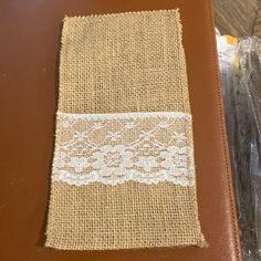 a piece of burlap with lace on it sitting on top of a table