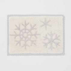 a white rug with snowflakes on it