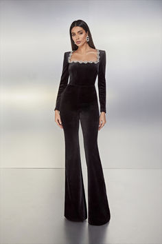 Own the occasion in KIMBERLY Jumpsuit. This sophisticated design is tailored for endless celebration. The luxurious black velvet jumpsuit features a square neckline with a statement jewel-embellished trim, shoulder pads, and internal corset boning to the bodice for shape and support. It is finished with a flared trouser and a zip at the back for a sleek finish. Luxury Black Jumpsuits And Rompers For Evening, Elegant Embellished Jumpsuits And Rompers For Cocktail, Elegant Embellished Cocktail Jumpsuits And Rompers, Luxury Jumpsuits And Rompers For Gala, Luxury Black Jumpsuits And Rompers For Formal Occasions, Luxury Black Formal Jumpsuits And Rompers, Luxury Fitted Jumpsuit For Formal Events, Luxury Fitted Jumpsuit For Formal Occasions, Luxury Fitted Jumpsuits And Rompers For Evening