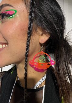 Take off on an intergalactic adventure with the Space Ranger Earrings! The ultimate accessory for those who have a passion for all things extraterrestrial. Carefully handmade with high-quality materials, these earrings are sure to last through every dance and festival adventure. - Made with lightweight acrylic for comfortable wear- Alien is UV-reactive green you can get the UFO ship either black glitter or uv reactive pink- Earring hooks are stainless steel, nickel-free, and hypoallergenic- Rubber backing included to keep things secure while you dance the night away! Rave Jewelry For Music Festival With Adjustable Fit, Handmade Adjustable Plug Earrings For Party, Rave Jewelry For Halloween Party, Handmade Rave Jewelry For Halloween, Handmade Rave Jewelry For Party, Funky Handmade Jewelry For Festivals, Funky Handmade Festival Jewelry, Handmade Funky Jewelry For Festivals, Unique Hoop Earrings For Party