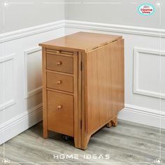 a small wooden cabinet sitting on top of a hard wood floor next to a white wall