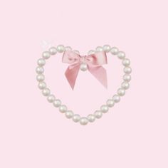 a heart shaped pearl necklace with a pink bow