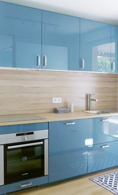 a kitchen with blue cabinets and an oven