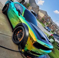 a colorful car parked on the side of a road