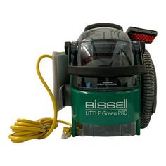 the bissel little green pro vacuum is plugged in and ready to be used