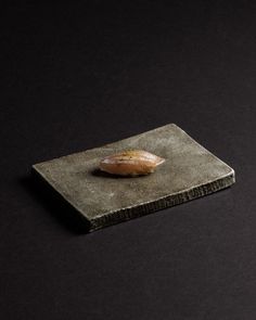 a piece of bread sitting on top of a stone