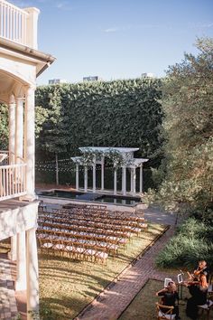 an outdoor ceremony with rows of chairs