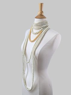 A one of a kind piece. This beautiful pearl statement necklace featuring a pearl choker with layers of long pearl strands.  Pearls are made of glass.  This necklace is a custom piece. The choker part requires an accurate measurement of the neck circumference if you would like it to sit tightly on the neck. If between sizes, please choose the shorter length. The choker is made with elastic material and the necklace comes with a 3" extender, it would be easier to adjust if it's a little tight. If the choker is loose, it won't stay on neck very well.  If it's a gift, we can make the choker part in the common length of13.5" with a 3" extender. If you would like the gold colored pearl to be a different color, please let us know, we have other color options. Thank you! Long Pearl Necklace For Party, Long Pearl Necklace With Pearl Chain For Party, Long Pearl Chain Necklace For Party, Long Pearl White Pearl Necklace For Party, Long Single Strand Pearl Necklace For Party, Multi-strand Pearl Chain Necklace For Party, Multi-strand Pearl Chain Beaded Necklaces For Party, Long Pearl Beaded Necklace For Party, Party Pearl Multi-strand Beaded Necklace