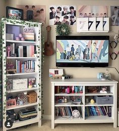 a flat screen tv sitting on top of a white book shelf