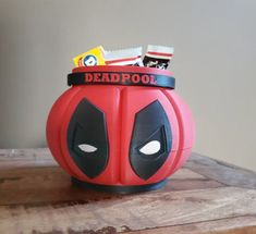 a deadpool pumpkin shaped container with candy in it