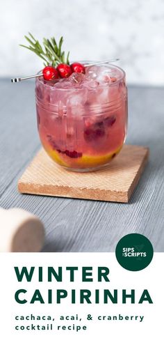 a drink with cranberries and oranges in it sitting on a wooden board