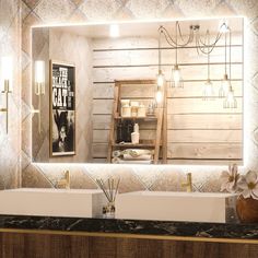 a bathroom with two sinks and a large mirror over it's counter top,