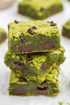 chocolate chip cookie bars stacked on top of each other with green frosting and chocolate chips