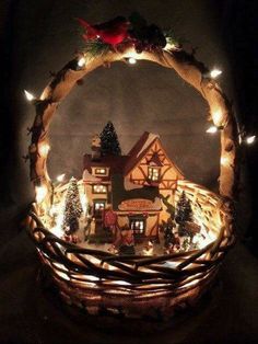 a lighted christmas village in a basket