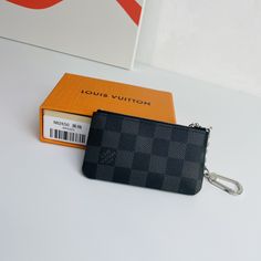 This Damier canvas pouch holds loose change and keys and slips easily into a handbag or coat pocket. Size: 12×7cm Gray Travel Bags With Card Slots, Black Pouch With Coin Pocket For Daily Use, Gray Bags With Card Slots For Everyday Use, Rectangular Travel Pouch With Key Clip, Everyday Gray Bag With Card Slots, Modern Black Wallet With Key Clip, Black Bags With Coin Pocket For Gifts, Black Bag With Coin Pocket As Gift, Pouch Bag With Key Clip For Gift