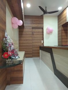 an empty room with balloons and flowers on the counter