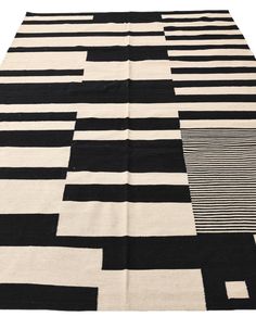 a black and white rug with squares on the bottom, diagonally arranged in rows