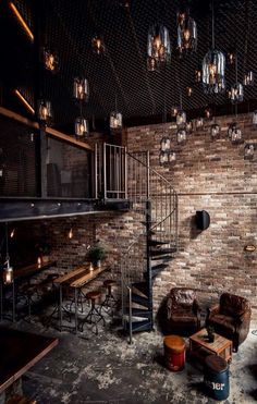 an industrial loft with brick walls and stairs