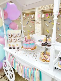 a table topped with lots of cakes and cupcakes on top of white tables