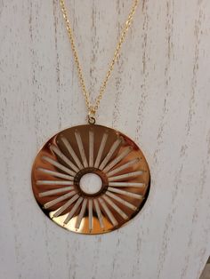 The necklace has a two inch round sun with 5mm cut out rays and a .50 inch round center circle shaped cut out.  18K gold plated/stamped ssteel. Circle Shape, Necklace Etsy, 18k Gold, Gold Necklace, Jewelry Necklace Pendant, Gold Plate, Plating, Jewelry Necklaces, Etsy Accessories