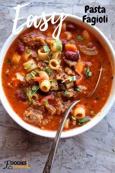 a white bowl filled with pasta and meat soup