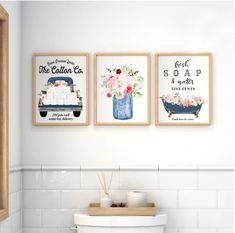 three framed pictures on the wall above a toilet