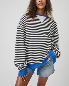 Free People Classic Striped Crew Style No. 82463712 So cool and classic, this timeless crewneck is featured in an oversized, slouchy silhouette and staple striped print with contrasting hems for added dimension. Fit: Relaxed, oversized fitFeatures: Crew neckline, dropped shoulders, contrast hemsWhy We <3 It: Lovely for layering or styling solo, this so tried and true piece is the perfect effortless essential your wardrobe has been wanting. Fit Note: This style may run large. For a truer fit, we Stripe Sweatshirt, Casual Pullover Sweater, Brown Sweatshirt, Oversize Pullover, Pull Oversize, Casual Long Sleeve Shirts, Striped Sweatshirts, Y2k Clothes, Loose Pullover