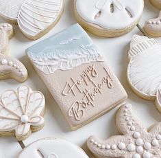 decorated cookies are arranged on a white surface