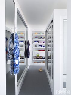 an empty walk - in closet with clothes and shoes