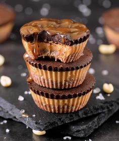 chocolate cupcakes stacked on top of each other with peanut butter drizzled on them