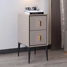 a nightstand with two drawers on top of it