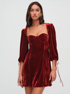 The perfect piece for the holiday seasonthe Nadine red mini dress is inherently festive. Crafted in a luxe velvet, this velvet dress has underwire cups, three-quarter blouson sleeves, and endless opportunities for nights out dancing. Holiday Velvet Mini Dress For Cocktail Events, Holiday Evening Velvet Mini Dress, Holiday Velvet Mini Dress For Evening, Elegant Velvet Mini Dress For Holidays, Fall Velvet Mini Dress For Cocktail, Fall Cocktail Velvet Mini Dress, Red Long Sleeve Velvet Party Dress, Red Long Sleeve Velvet Dress For Party, Cocktail Dress Christmas Party