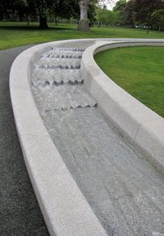 a water fountain in the middle of a park