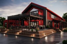 a large red building with lights on it's front porch and stairs leading up to the second floor