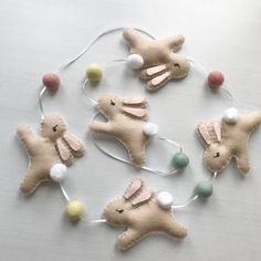 four stuffed animals are connected to string lights on a table with other decorations around them