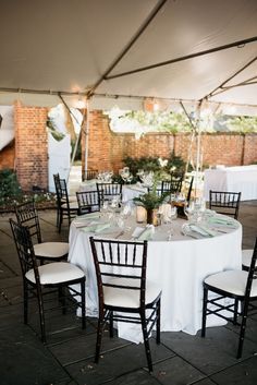 the tables are set up with white linens